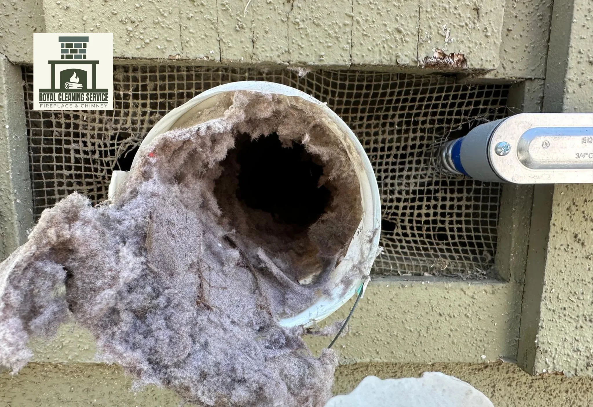 Technician cleaning a dryer vent exterior line on a Southern California home