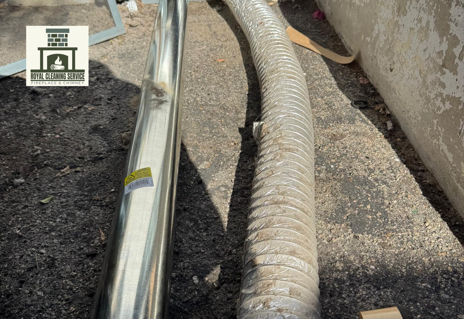 Royal Cleaning Service technician installing rigid metal dryer vent duct in Los Angeles home